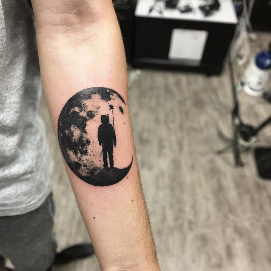 fresh ink tattoo of a man on the moon, on my outer forearm